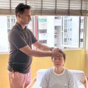 Students of Reiki 2 workshop on 26 Jul 2025 practicing reiki with Reiki 2 symbols on each other 
